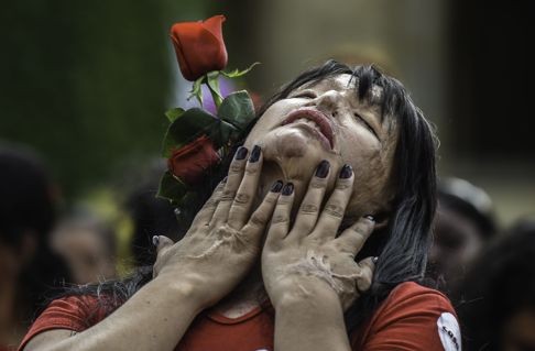 Colombian Patricia Espitia, the victim of an acid attack, performs during this year’s International Day for the Elimination of Violence against Women in Bogota. Photo: AFP