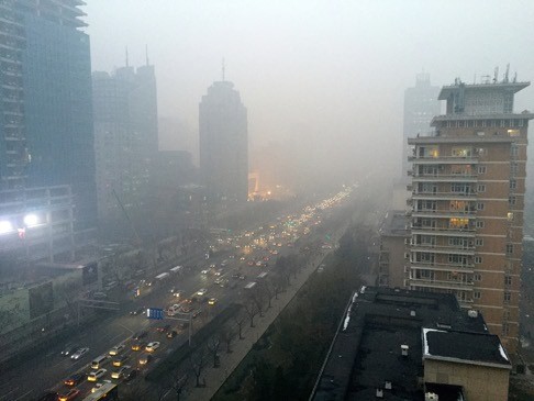 Smog hangs over Beijing's main boulevard, Changan Avenue, just as the UN climate change summit got under way in Paris. Photo: TNS