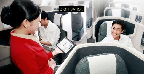 Cathay Pacific stewardesses have already got used to servicing passengers in business class using tablets as the airline moves towards greater digitisation. Photo: Handout