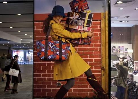 An advertisement at a Beijing shopping mall. The government must shift income to the household sector by decreasing contributions to social welfare funds, and cutting consumption and income taxes. Photo: AP