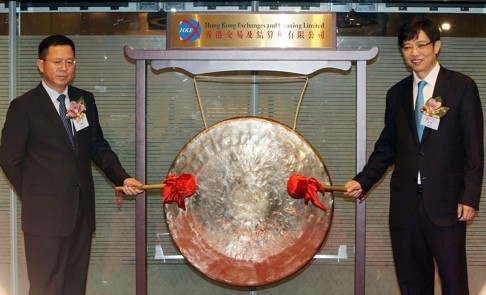 Huatai Securities chairman Wu Wanshan (left) and executive director and president Zhou Yi ring the gong at its listing ceremony on June 1. Photo: Franke Tsang