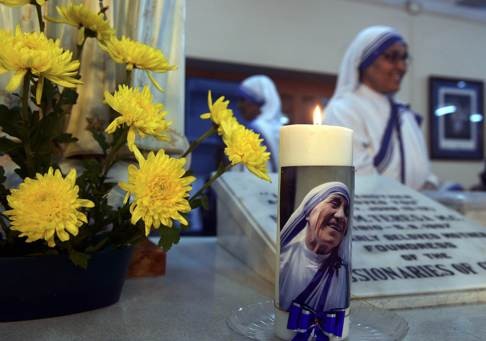 Nuns stand alongside Mother Teresa’s tomb at a special prayer service in Calcutta. There is no story to parallel or equal Mother Teresa’s journey. Photo: AFP