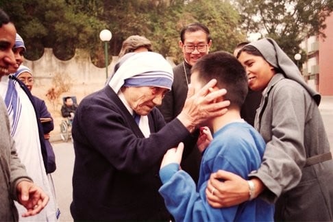 Mother Teresa blesses a child in Macau. With children and the severely ill, her embrace was at its fullest. Photo: SCMP Pictures