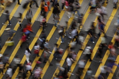 People cross the road in Mong Kok, one of the most densely populated districts in the world. A comprehensive elevated pedestrian network is desperately needed to alleviate overcrowding on the streets. Photo: Reuters