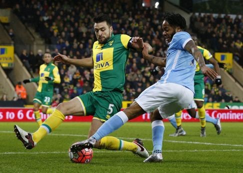 Raheem Sterling takes on Russell Martin. Photo: AFP