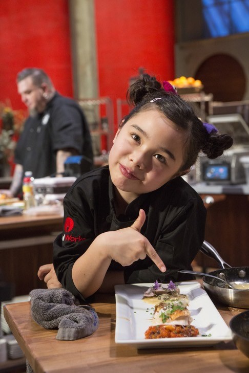 Estie Kung shows viewers one of her creations on the show, which each week pits its five child cooking prodigies against a professionally trained adult chef in the kitchen.
