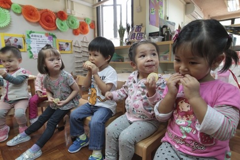 Kids taste lemons in kindergarten class at the Hong Kong Institute of Education in Tai Po.