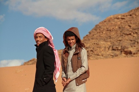 The film’s lead actors, Bedouins Jacir Eidal-Hwietat (right) and his cousin, Hussein Salameh al-Sweilhiyeen, pose for a photo in Wadi Rum, southern Jordan. The pair (below) in a scene from the film. Photo: AP