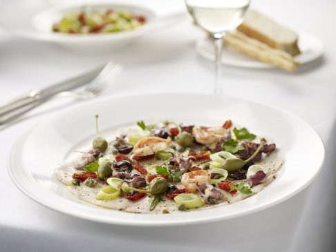 Gradini's baked sea bass carpaccio with baby calamari, prawns, olives and capers.