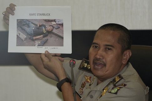 Jakarta Police medical division chief officer Musyafak shows a photo of suspected dead militant identified as Afif, alias Sunakin. He was one of the convicts influenced by Islamist cleric Aman Abdurrahman while an inmate at Cipinang prison. Photo: Reuters