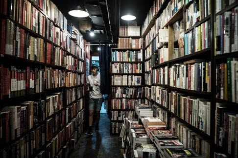 An employee walking past shelves in a bookstore in the Causeway Bay district in Hong Kong. Photo: AFP