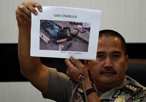 Jakarta Police medical division chief officer Musyafak shows a photograph of killed militant Afif, also known as Sunakin. Indonesia has identified Afif as a previously jailed militant. Photo: AFP