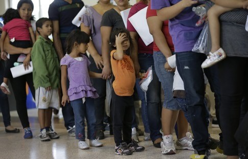 Immigrants who entered the US illegally stand in line for tickets at a bus station after being released from a US border protection facility in Texas. Photo: AP