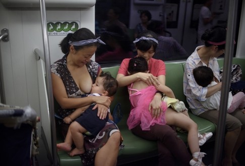Chinese mothers breastfeed their babies on a subway train during an event to promote the practice among working mothers. Photo: AFP