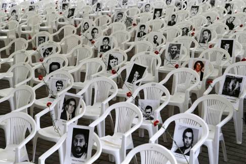 Pictures of victims of human rights abuses during Pinochet’s rule of Chile are displayed before a ceremony at the Park for Peace, on the grounds of the former Villa Grimaldi torture centre in Santiago. Photo: Reuters