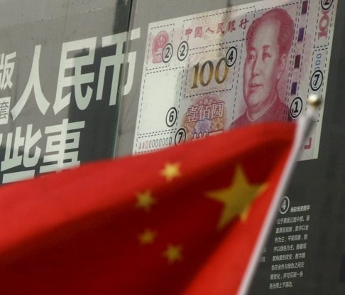 A Chinese flag is seen in front of a poster explaining the design of the new 100-yuan banknote at a branch of a commercial bank in Beijing. Chinese banks, under pressure from the government, are always willing to kick the can of non-performing loans down the road. Photo: Reuters