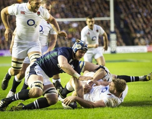 England’s George Kruis scores his first international try as David Denton attempts a late tackle. Photo: EPA