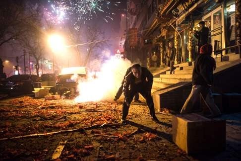 Though Beijingers rang in the new year in traditional style on this street, the city felt fewer bangs this year. Photo: AFP