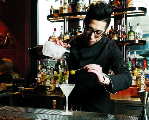 Bartender Kevin Zee mixes a dry martini at VEA.