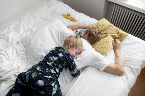 In getting kids to sleep through the night some parenting experts advise letting infants sleep with parents. Photo: Corbis