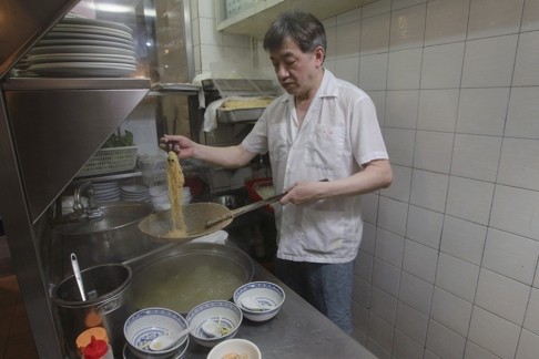 Chan Siu-lung strains wonton noodles in the kitchen at Mak’s Noodle in Central. Photo: Edward Wong