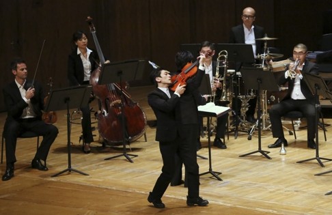 A scene from the Hong Kong Sinfonietta’s A Soldier’s Story – The New Generation featuring Japanese dancer Hikaru Tsutagawa (dancing with a violin).