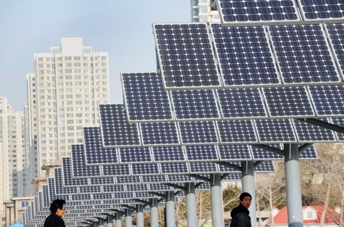 Residents walk past solar power panels installed for public electricity supply in Shenyang in northeast China's Liaoning province. China’s coal market was starting to become saturated and “should gradually decline”, climate envoy Xie Zhenhua says. Photo: AFP