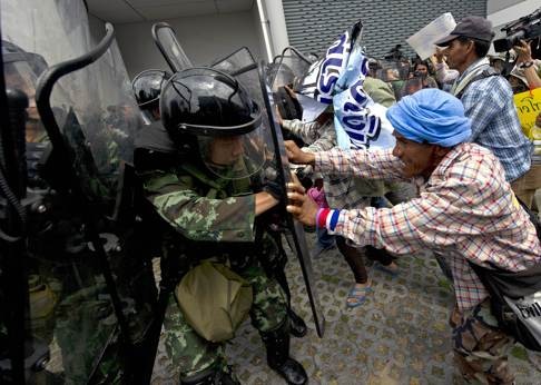 Thai farmers battle with soldiers as they protest the government's repeatedly delayed payments for a rice subsidy scheme. Critics argued the scheme amounted to buying the farmers’ votes. Photo: AFP