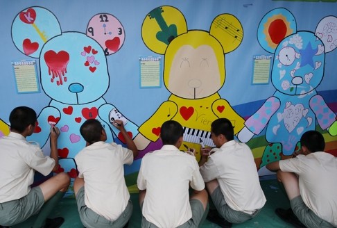 Inmates take part in an arts workshop at the Cape Collinson correctional institution. Those who did not complete their high school education are given a chance to do so while they serve time. Photo: Jonathan Wong