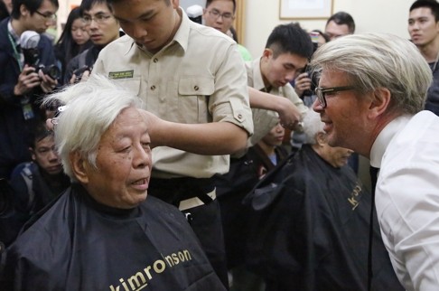 Celebrity hair stylist Kim Robinson teaches young inmates from the Cape Collinson training centre to cut the hair of the elderly at a nursing home. Photo: SCMP Pictures