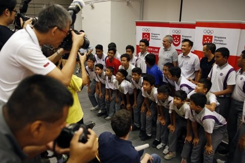 Former Chelsea manager Jose Mourinho poses with students of NorthLight School during a visit in Singapore. Photo: Reuters