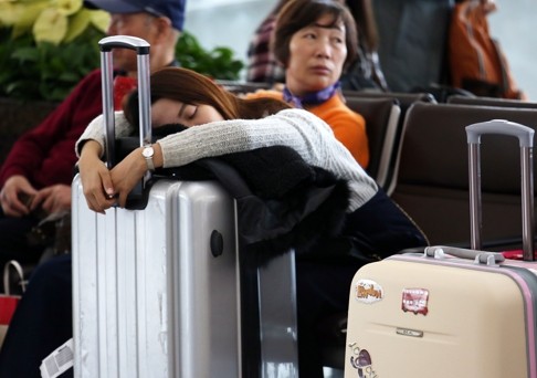 Visitors wait for their flight at the Hong Kong airport. Overall visitor numbers to the city fell last year, but the figure still surpassed the 50 million threshold. Photo: Nora Tam