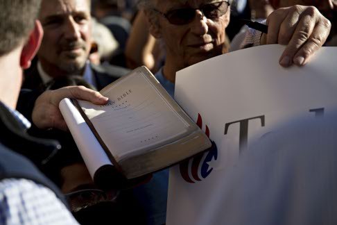 Bad words about the good book. Ted Cruz supporters hold out a Bible for the Texas presidential candidate to sign after his staffer claimed falsely that Cruz’s opponent Marco Rubio said the religious text held “not many answers”. Photo: Bloomberg