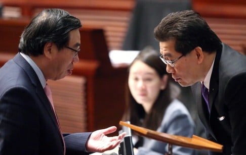 Secretary for Commerce and Economic Development Greg So (right) speaks to legislator Andrew Leung during the second reading of the copyright amendment bill. Photo: K. Y. Cheng