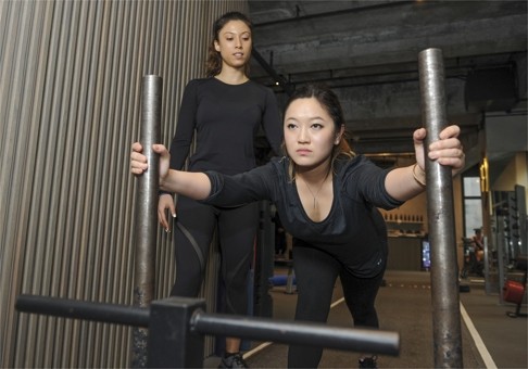 It’s much harder than it looks: Elizabeth Wu pushing the Prowler as personal trainer Heanney McCollum checks her form.