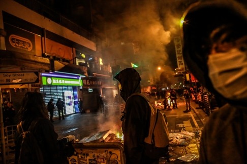 Fires burn as groups of mostly young people run riot in Mong Kok. Disenchantment is being used as an excuse for intimidation and violence. Photo: Bloomberg