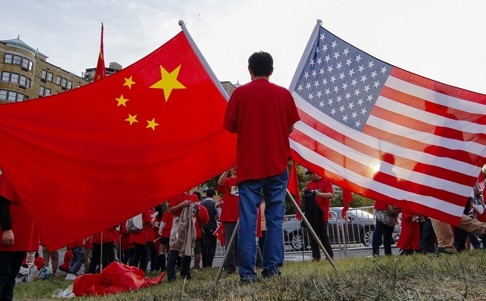Demonstrators hold up China’s and the United States’ national flags as they gather at sunset in Washington ahead of Chinese President Xi Jinping’s state visit last year. Photo: EPA