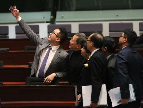 Newly elected legislator Alvin Yeung takes a selfie with his fellow Civic Party lawmakers before the swearing-in ceremony at Legco chambers. Photo: Nora Tam