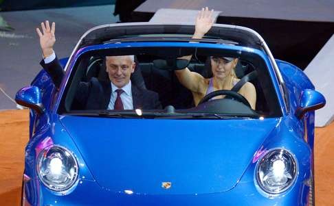 Maria Sharapova drives the winner's price, a Porsche 911, next to Porsche CEO Mathias Mueller. He’ll be among those hoping the business relationship can continue after a slight bump in the road. Photo: AFP