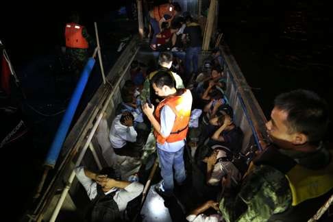 The border-control armed police checked a human smuggling boat in the sea in China’s southern city Shenzhen. Photo: Xinhua