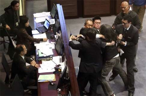 Lawmaker “Long Hair” Leung Kwok-hung is restrained before the finance committee chairman. Photo: Felix Wong