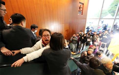 Protesters outside the legislative council chamber on Friday drew the attention of security and media. Photo: Felix Wong