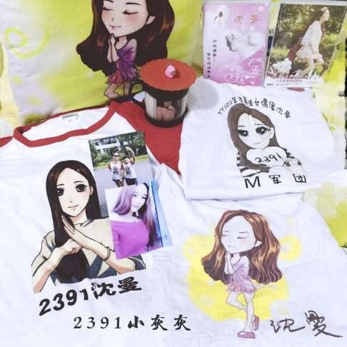 A collection of Shen Man memorabilia by fan Shen Hui Hui, 20, includes a pillow, three T-shirts, two CDs, and a mug.