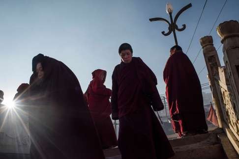 Buddhist nuns leave the monastery after praying at the Larung Gar Buddhist Institute in Sertar county (known as Seda in Chinese) in the remote Garze Tibetan autonomous prefecture in southwest China.