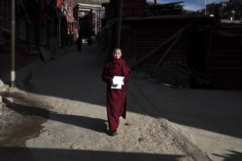 A nun walks to the Buddhist institute in Sertar county. One activist nun says: “We need to teach women to stand up for themselves.”