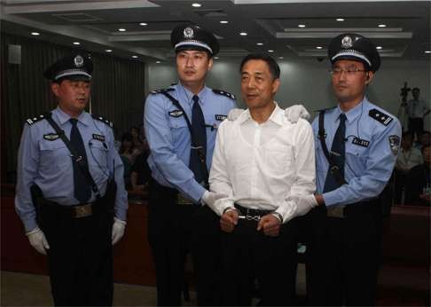 Former Chongqing Communist Party boss Bo Xilai stands in a courtroom in Jinan, Shandong province, in this photo taken in 2013. Televised courtroom trials amount to “sacrificial lamb” shows. Photo: AFP