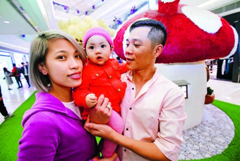 Tran Trong Manh (right), a former detainee at a Vietnamese refugee camp in Hong Kong, with his wife, Doan Thanh Hai, and nine-month-old daughter Tran Yau Chin in Yuen Long. Photo: Edward Wong