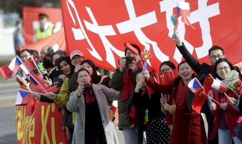 Chinese supporters cheer for President Xi Jinping as he arrives in Prague. Photo: Reuters