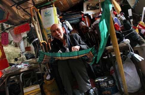 Umbrella repairer Ho Hung-hee, pictured in his Peel St stall in 2010. Photo: SCMP