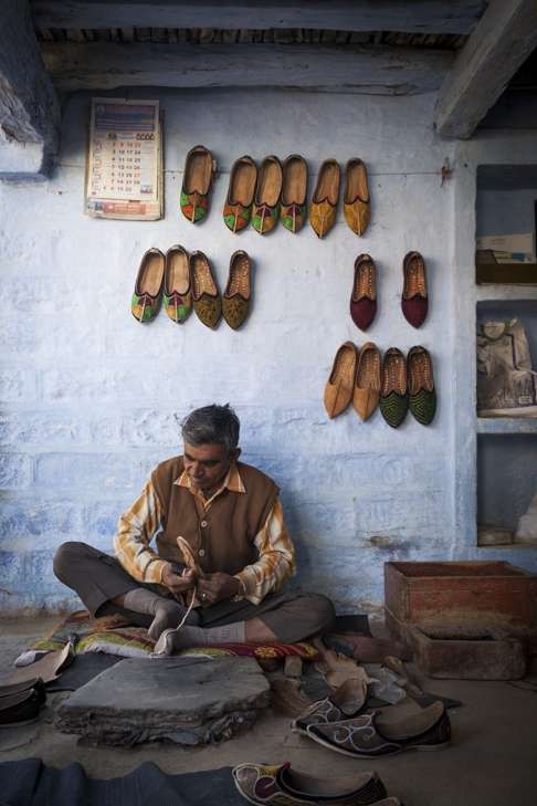A traditional shoemaker in Rajasthan, plying a trade that automation and globalisation is rendering ever more precarious. Photo: Corbis